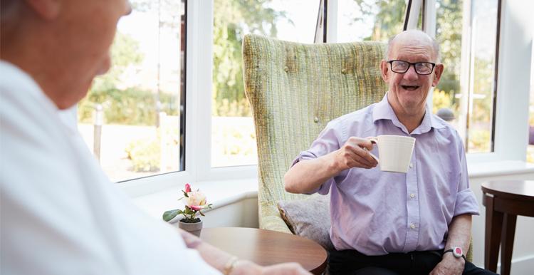 Man Talking to Elderly Man