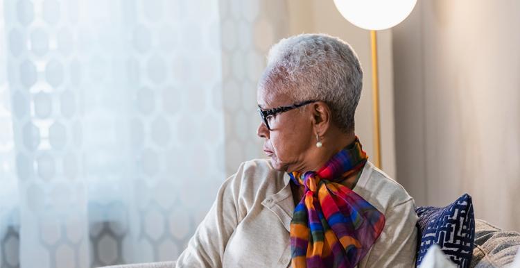 Lonely woman looking out of window