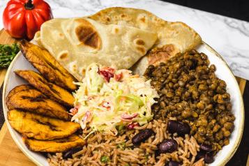 Plate of rice, plantain, beans, and veggies 