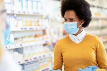 Woman in pharmacy in mask Covid