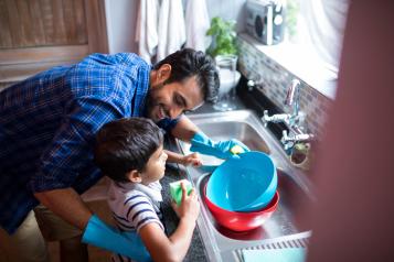 Father and child washing up