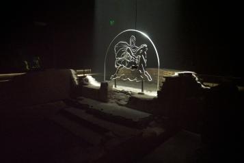 Image of Mithraeum Symbol in glass and illuminated in the dark ruins