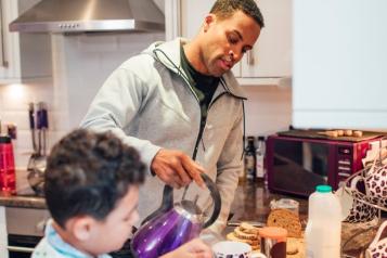 Older man makes tea with child