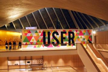 Inside the Design musuem, showing large mural made up of different coloured triangles