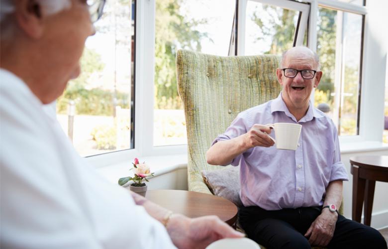 Man Talking to Elderly Man